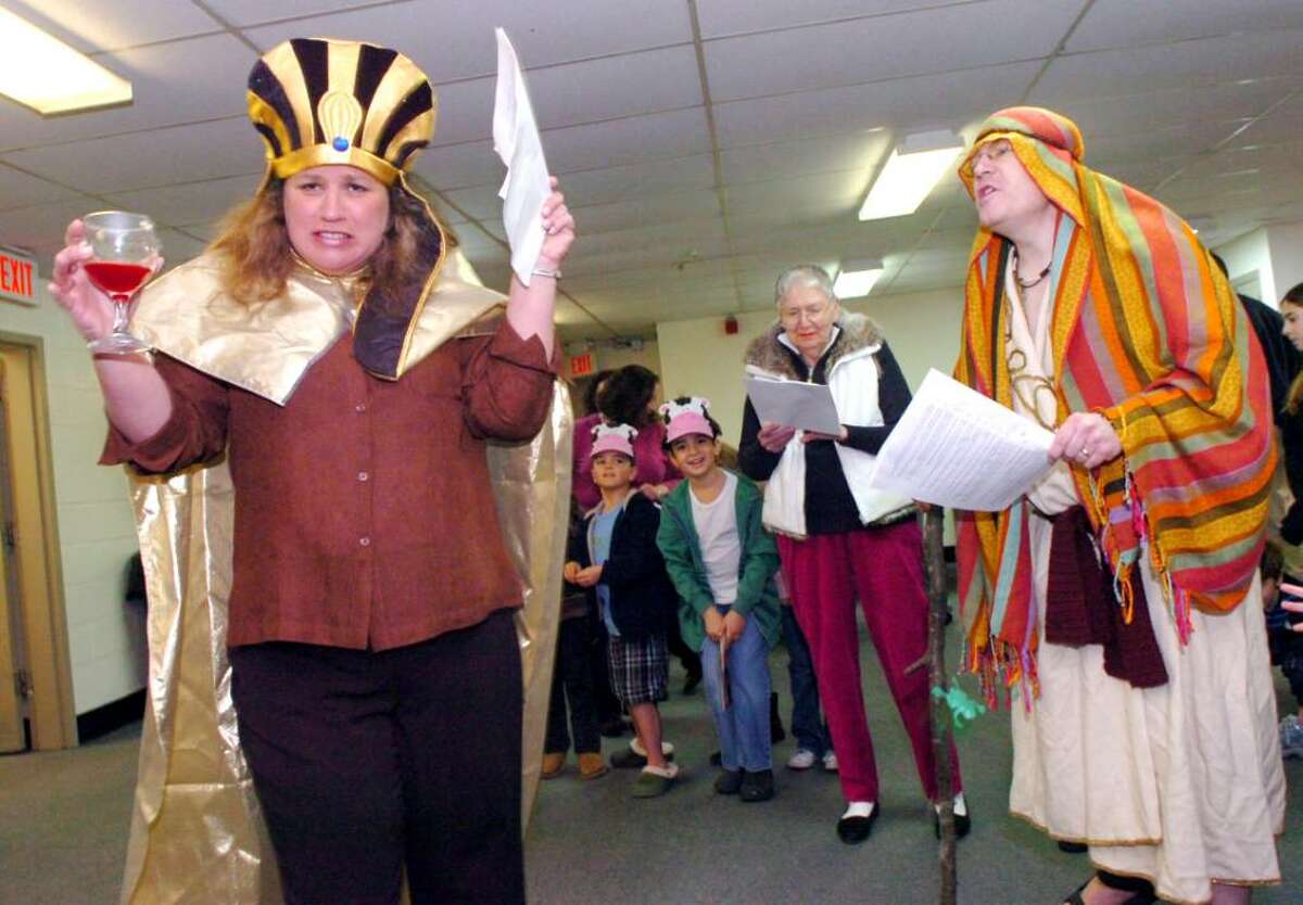 Jane Aronson, 7th grade teacher and past director of education at the Greenwich Reformed Synagogue Hebrew School, plays the pharoh, fighting with Rabbi Andrew Sklarz as Moses, in the reenactment of the Jews' exodus from Egypt, on Sunday, March 28, 2010.