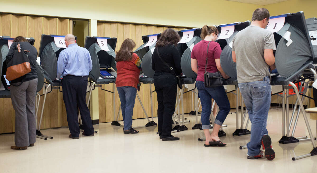 Voters cast ballots at the Metropolitan Multi-Services Center, with the crowd reflecting the high turnout.