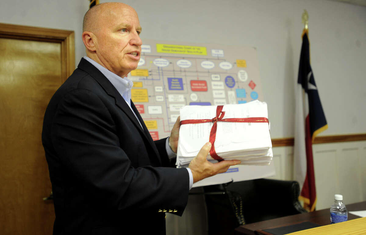 Representative Kevin Brady holds up a copy of the proposed HR3200 bill to reform health care during a town hall meeting at the Jasper Subcourthouse in Buna, Wednesday. Tammy McKinley, The Enterprise