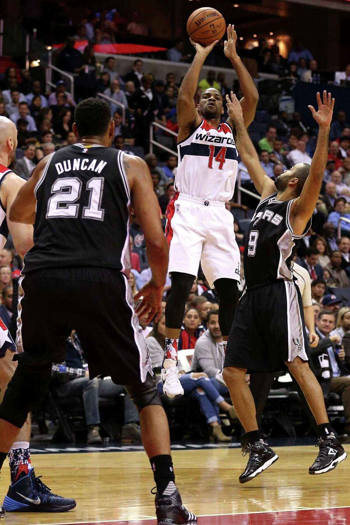 WASHINGTON, DC - NOVEMBER 04: Gary Neal #14 of the Washington Wizards shoots in front of Tony Parker #9 of the San Antonio Spurs during the first half at Verizon Center on November 4, 2015 in Washington, DC. NOTE TO USER: User expressly acknowledges and agrees that, by downloading and or using this photograph, User is consenting to the terms and conditions of the Getty Images License Agreement.