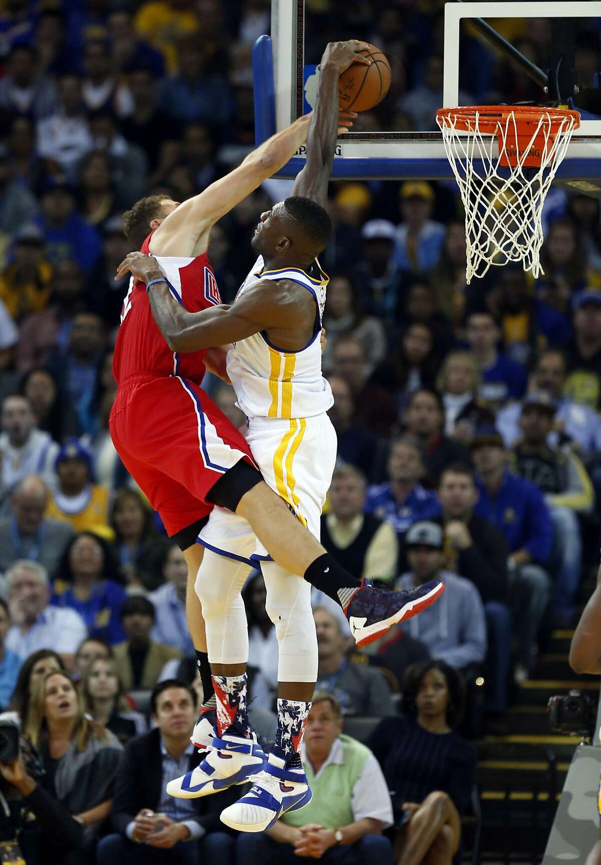 Golden State Warriors' Festus Ezeli blocks a dunk attempt by Los Angeles Clippers' Blake Griffin in 1st quarter during NBA game at Oracle Arena in Oakland, Calif., on Wednesday, November 4, 2015.