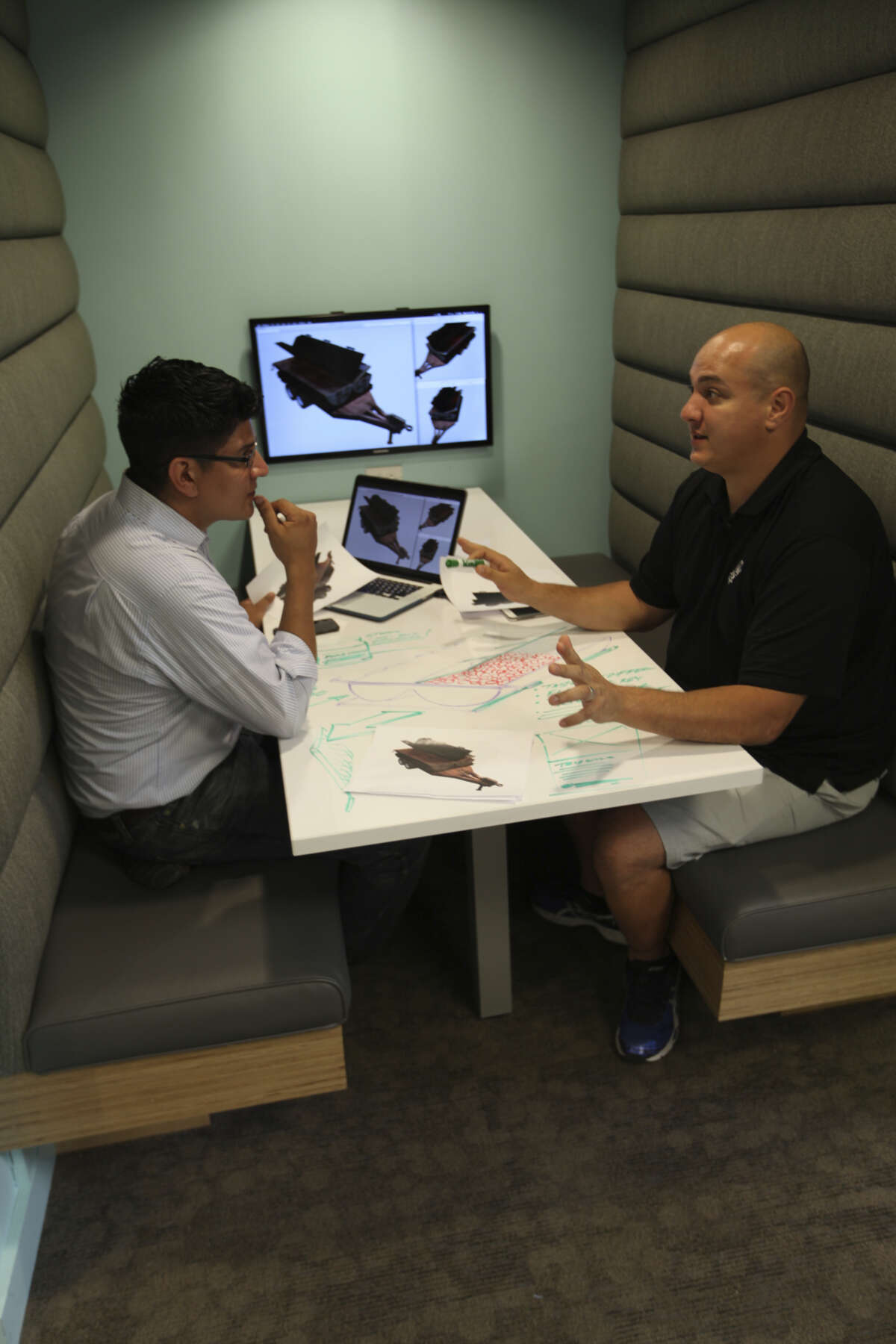Ernest Flores (left) and Dominic Mendiola plot the design of their one-of-a-kind grill for Dom's Chop Salsa company.