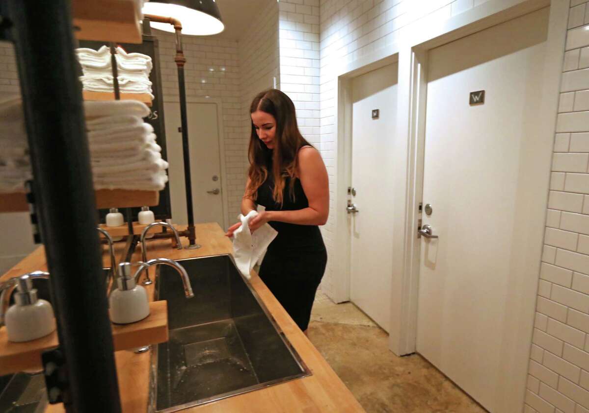 Britany Devlin uses the communal bathroom at The Pass & Provisions restaurant on Thursday. "To me it wasn't a bathroom ordinance, it was an equal rights."﻿