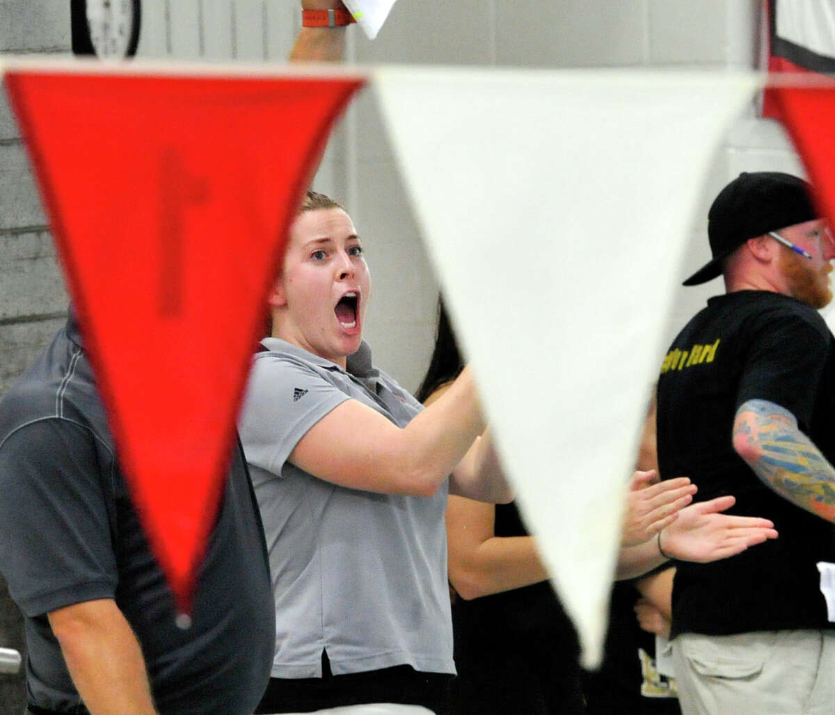 New Canaan High School assistant swimming coach Kat Munson cheers on her team during the final race of the girls FCIAC swimming championship at Greenwich High School, Greenwich, Conn., Thursday, Nov. 5, 2015. New Canaan won the championship and Ridgefield was second.