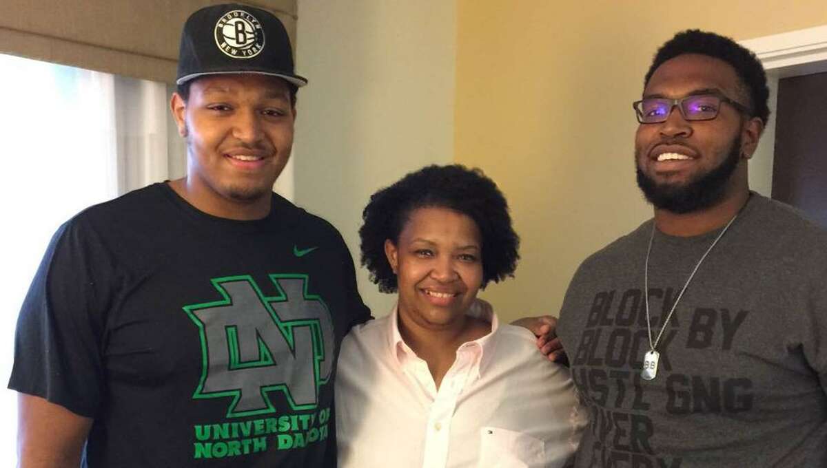A&M's Hardreck Walker, right, met his ﻿brother, North Dakota's Austin Cieslak, for the first time this fall. The two linemen sandwich their mom, Morgan Hall﻿.