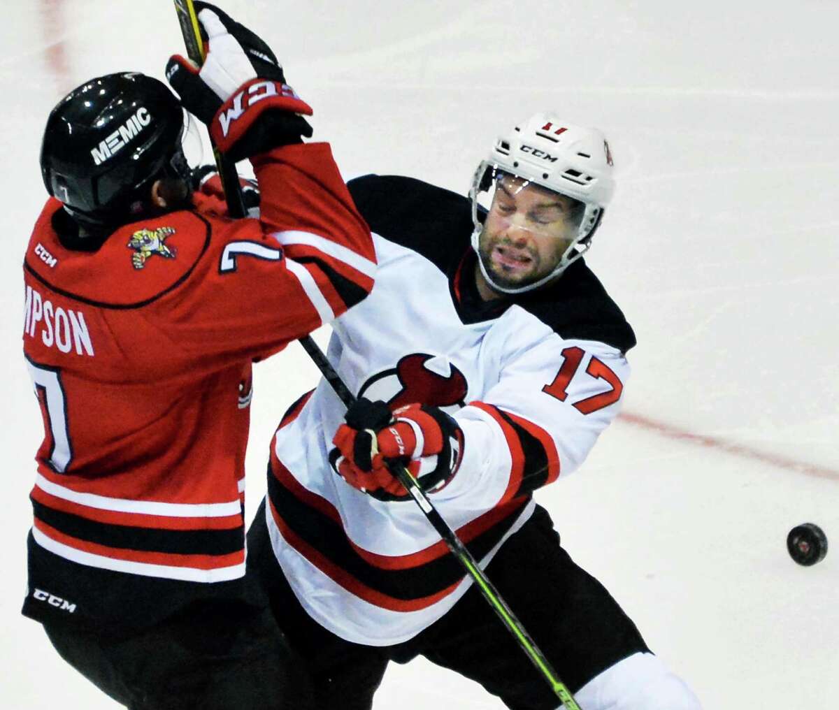Albany Devils' #17 Marc-Andre Gragnani, right, battles Portland Pirates' #7 Wayne Simpson for the puck during Saturday's game at the Times Union Center Oct. 24, 2015 in Albany, NY. (John Carl D'Annibale / Times Union) ORG XMIT: MER2015102419101720