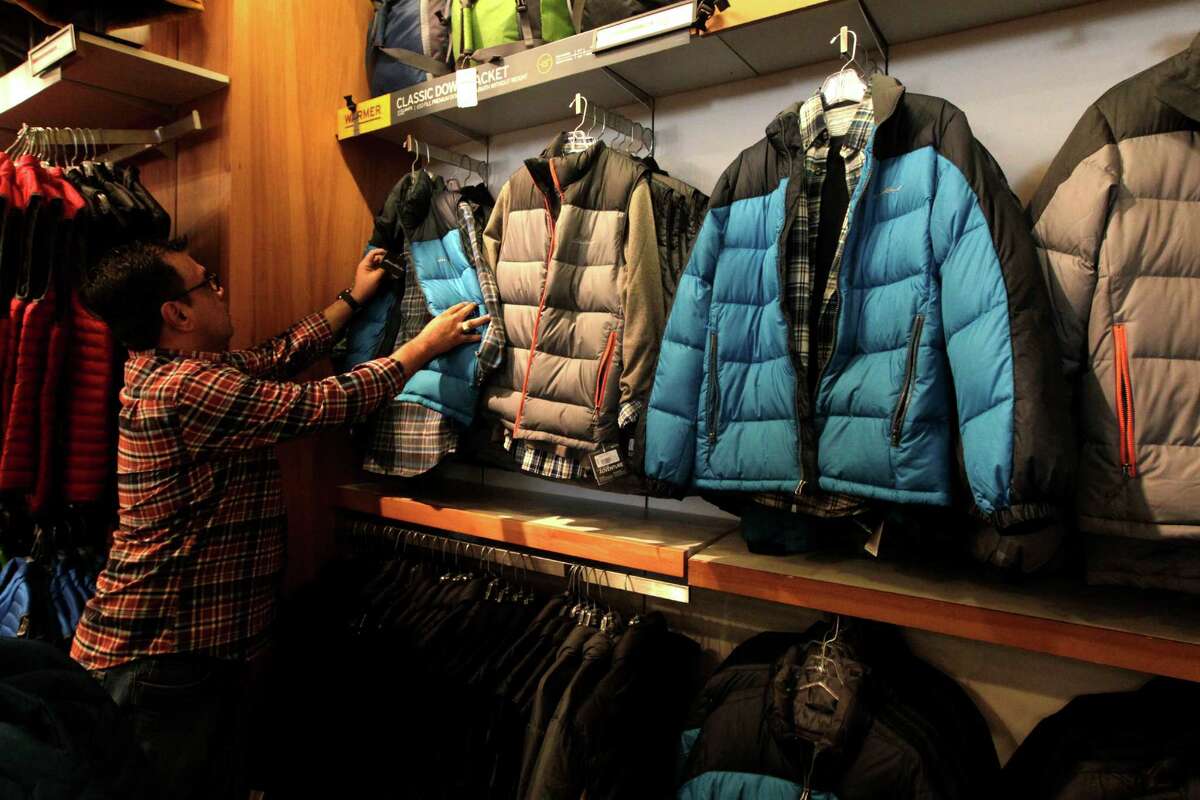 Eddie Bauer's employee Johnny Bejanero straightens out jackets in preparation of the holiday shopping season at the Houston Premium Outlets on Thursday, Nov. 5, 2015, in Cypress. ( J. Patric Schneider / For the Chronicle )
