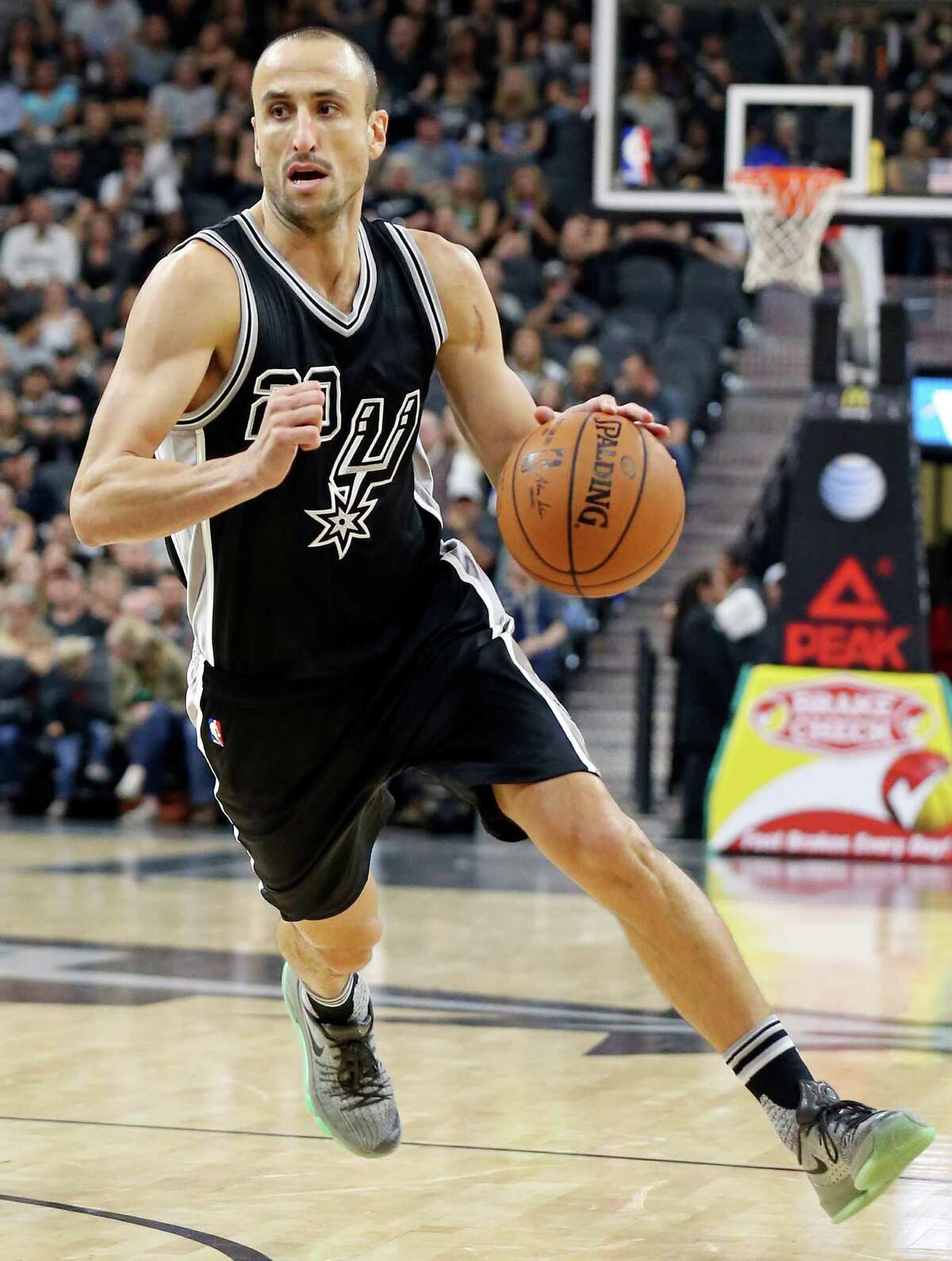 Spurs’ Manu Ginobili drives to the basket during first half action against the Brooklyn Nets on Oct. 30, 2015 at the AT&T Center.