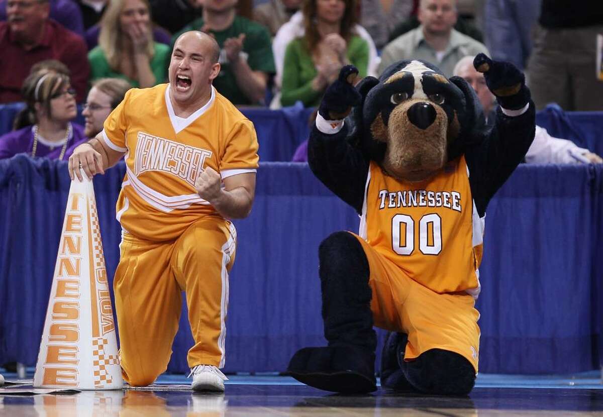 ST. LOUIS - MARCH 26: Smokey, the Tennessee Volunteers mascot, and a cheerleader celebrate the win over he Ohio State Buckeyes during the midwest regional semifinal of the 2010 NCAA men's basketball tournament at the Edward Jones Dome on March 26, 2010 in St. Louis, Missouri. Tennessee defeated Ohio State 76-73. (Photo by Elsa/Getty Images)