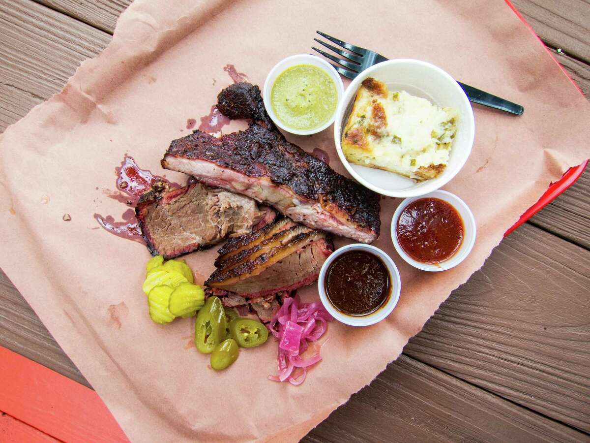 Ribs and brisket with tomato, tomatillo and mole sauces, and corn pudding at Tejas Chocolate in Tomball