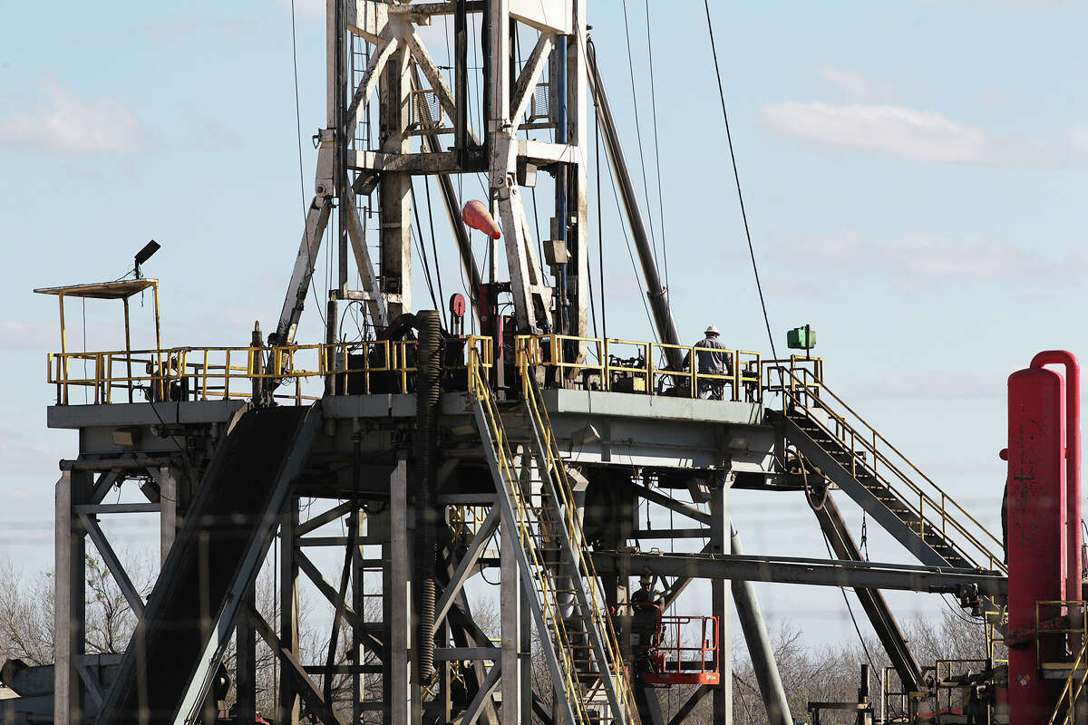 Work continues on a drilling rig off Texas State Highway 72 east of Tilden, Texas, Thursday, February, 19, 2015. A drop in the price of crude oil from has led to lower prices at the pump for consumers. Hovering close to $50 from a high of over $100 per barrel of oil has led to a slow down activity in the Eagle Ford Shale play.