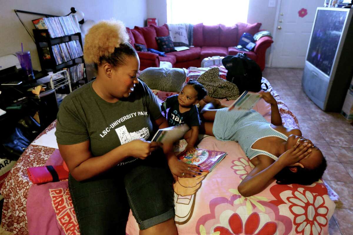Jessica Vaughn, with nephew Reidyn Hall, 9 months, and daughter Chrysta Jenkins, 8, slept on an air mattress in her mother's home as she searched for a new apartment.