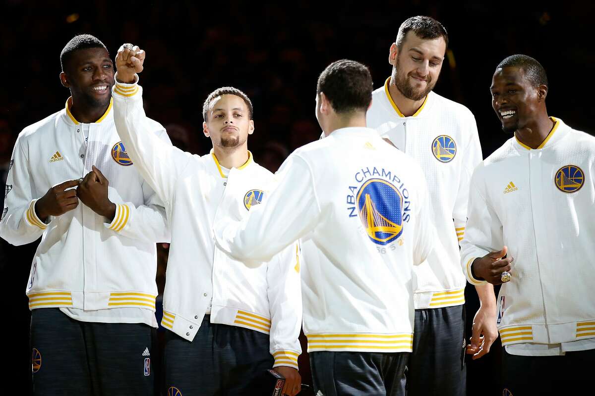 OAKLAND, CA - OCTOBER 27: Festus Ezeli #31, Stephen Curry #30, Klay Thompson #11, Andrew Bogut #12 and Harrison Barnes #40 of the Golden State Warriors celebrate after receiving their championship rings prior to their game against the New Orleans Pelicans in the NBA season opener at ORACLE Arena on October 27, 2015 in Oakland, California. NOTE TO USER: User expressly acknowledges and agrees that, by downloading and or using this photograph, User is consenting to the terms and conditions of the Getty Images License Agreement. (Photo by Ezra Shaw/Getty Images)