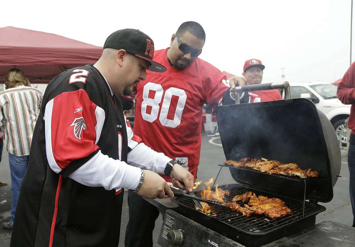 Fans tailgate before an NFL football game between the Atlanta