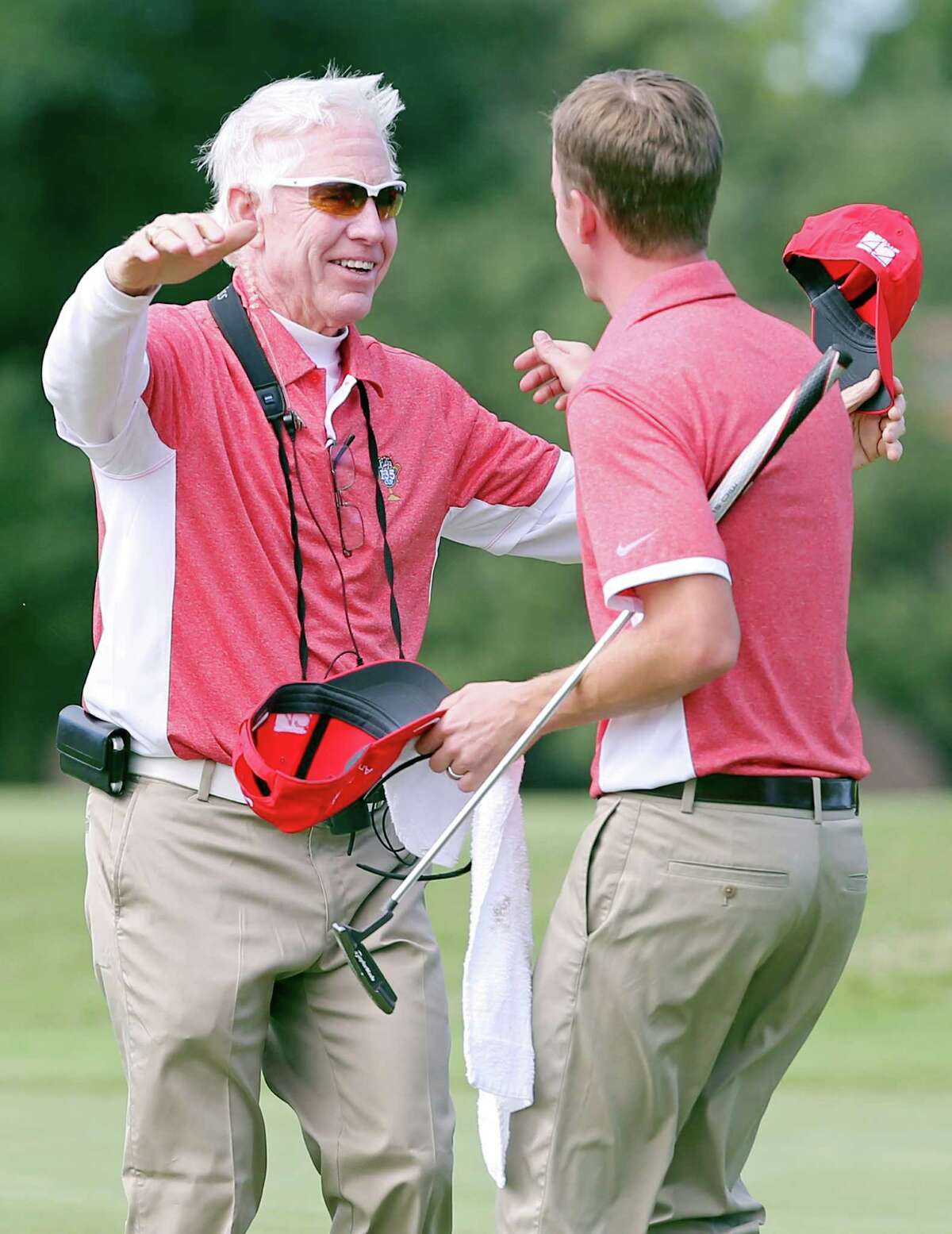 Team San Antonio captain Pat McMahan (left) celebrates with teammate Ross Wilhelm on 17, after Wilhelm made his putt during the Rudy’s I-35 Cup at Fair Oaks Ranch Golf & Country Club.