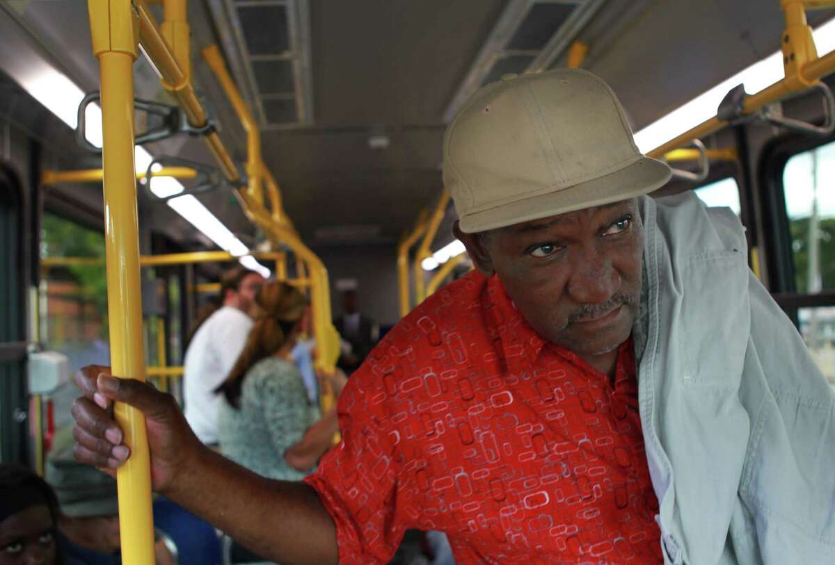 Larry Jackson looks for his stop while riding Metro's Route 85 bus out of downtown on Nov. 5.