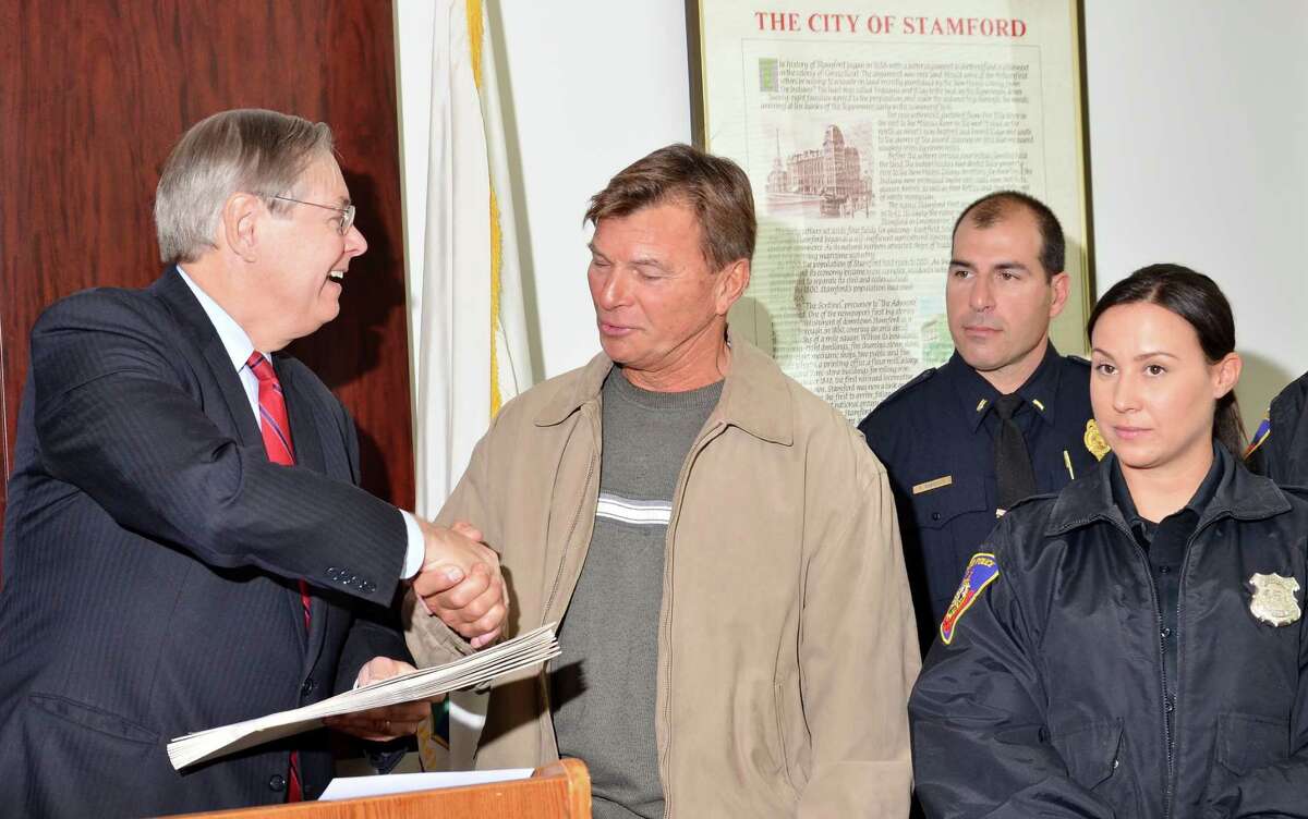 Mayor David Martin, left, issued a commendation Monday to Detective Bureau Sgt. Paul Guzda and his squad for the quick arrests in last Monday night's Lione Park murder. Standing to Guzday’s left is Officer Nicole Petrenko, who spotted the vehicle carrying the three suspects who have been charged with the murder of of 43-year-old Maxine Gooden, a mother of five.