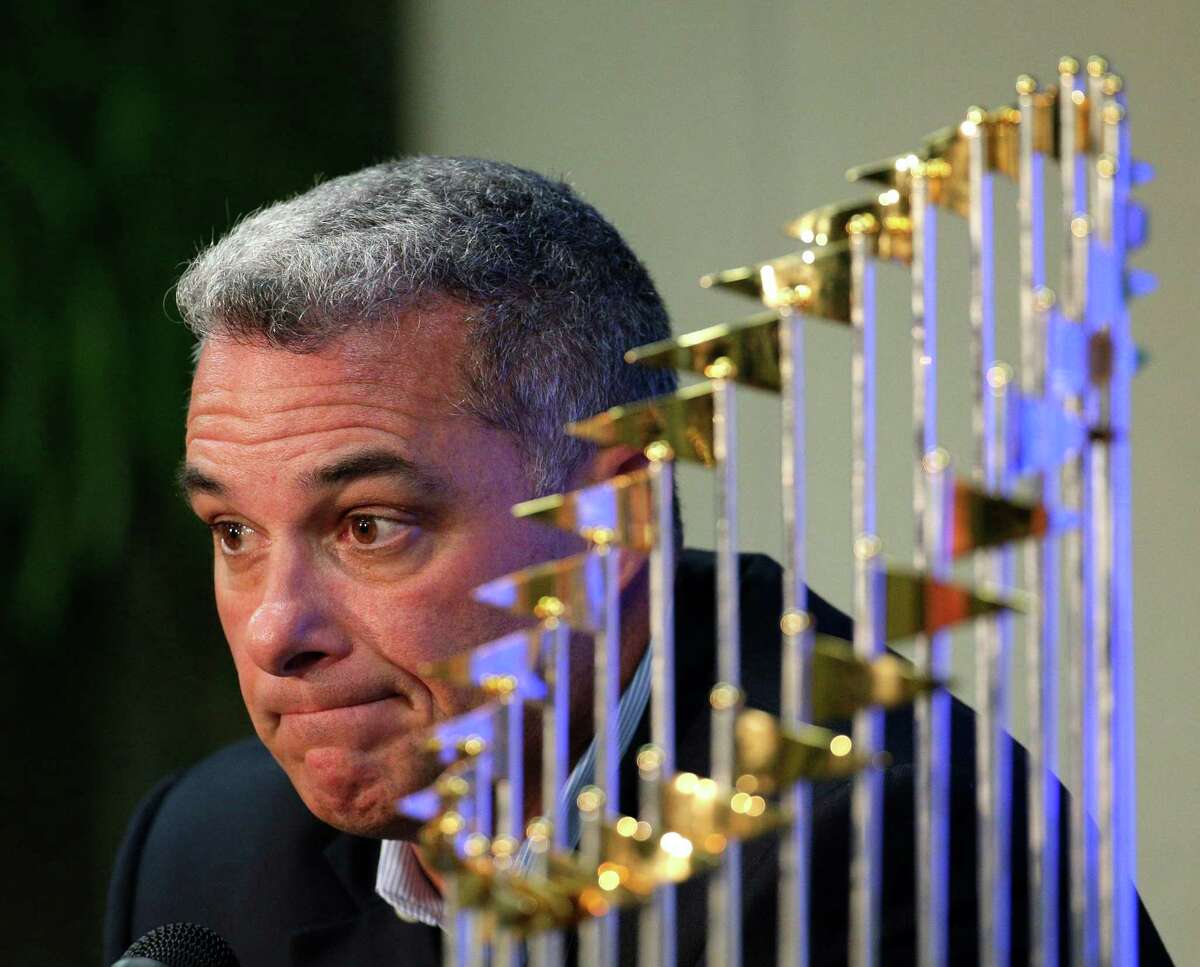 Kansas City Royals general manager Dayton Moore speaks to members of the media alongside the Royals' World Series trophy during a news conference wrapping up the team's season Thursday, Nov. 5, 2015, in Kansas City, Mo. The Royals capped their season by defeating he New York Mets in five games to win baseball's World Series. (AP Photo/Charlie Riedel)