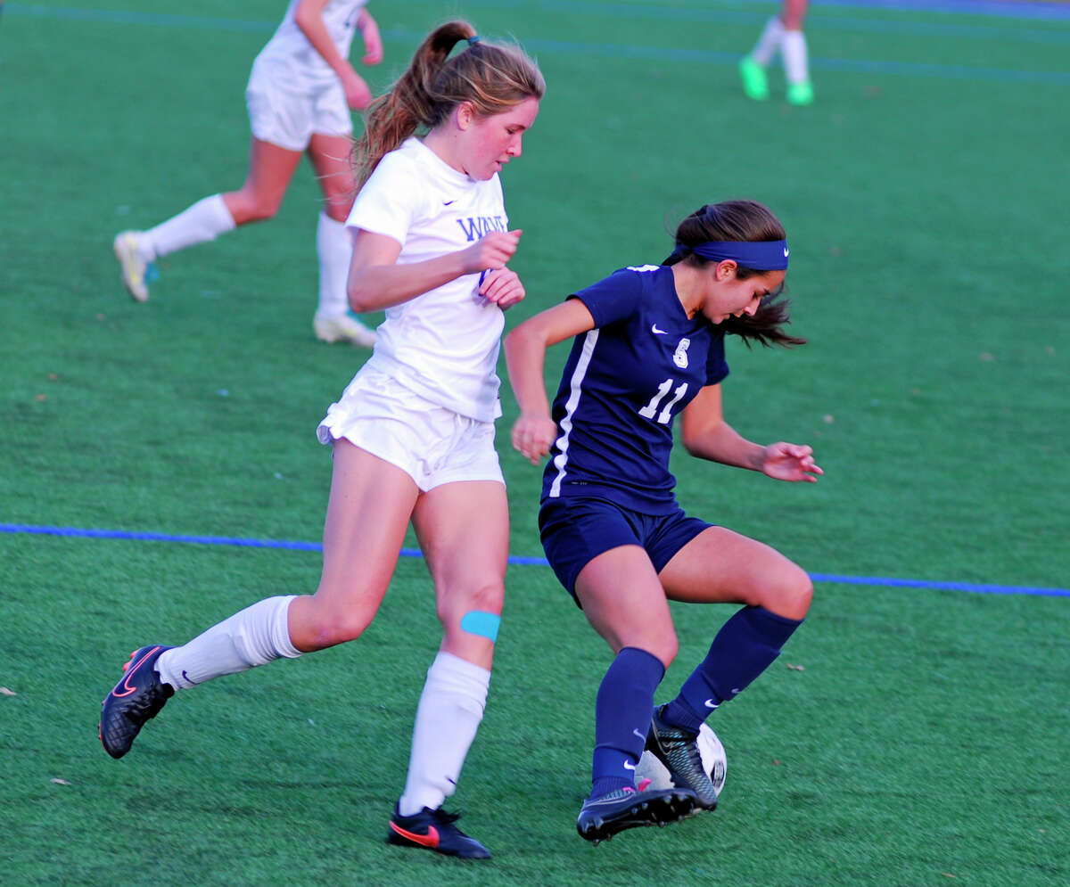 Staples' Tia Zajec, right, spins away from a Darien player during a girls soccer game in Darien, Connecticut on Monday, November 9th, 2015. Darien won 2-1 to advance to the Class LL second round.