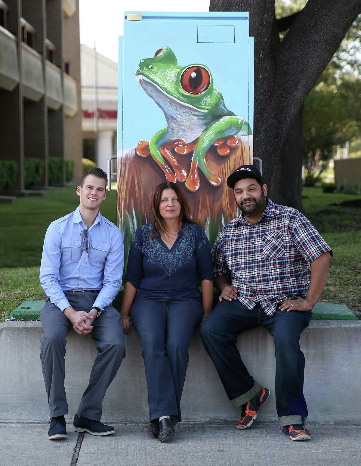 Louis Jullien, muralist Anat Ronan and UP Art Studio Noah Quiles sit in front of a mini mural Ronan did in Houston that was mistakenly painted over 20 hours after she first painted it by Houston's anti-graffiti task forest. Monday, Nov. 9, 2015, in Houston.