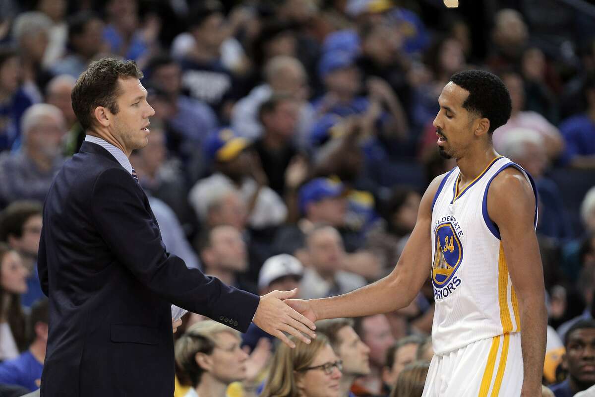 Interim head coach Luke Walton high fives Shaun Livingston (34) as he comes off the court in the second half as the Golden State Warriors played the Detroit Pistons at Oracle Arena in Oakland, Calif., on Monday, November 9, 2015.