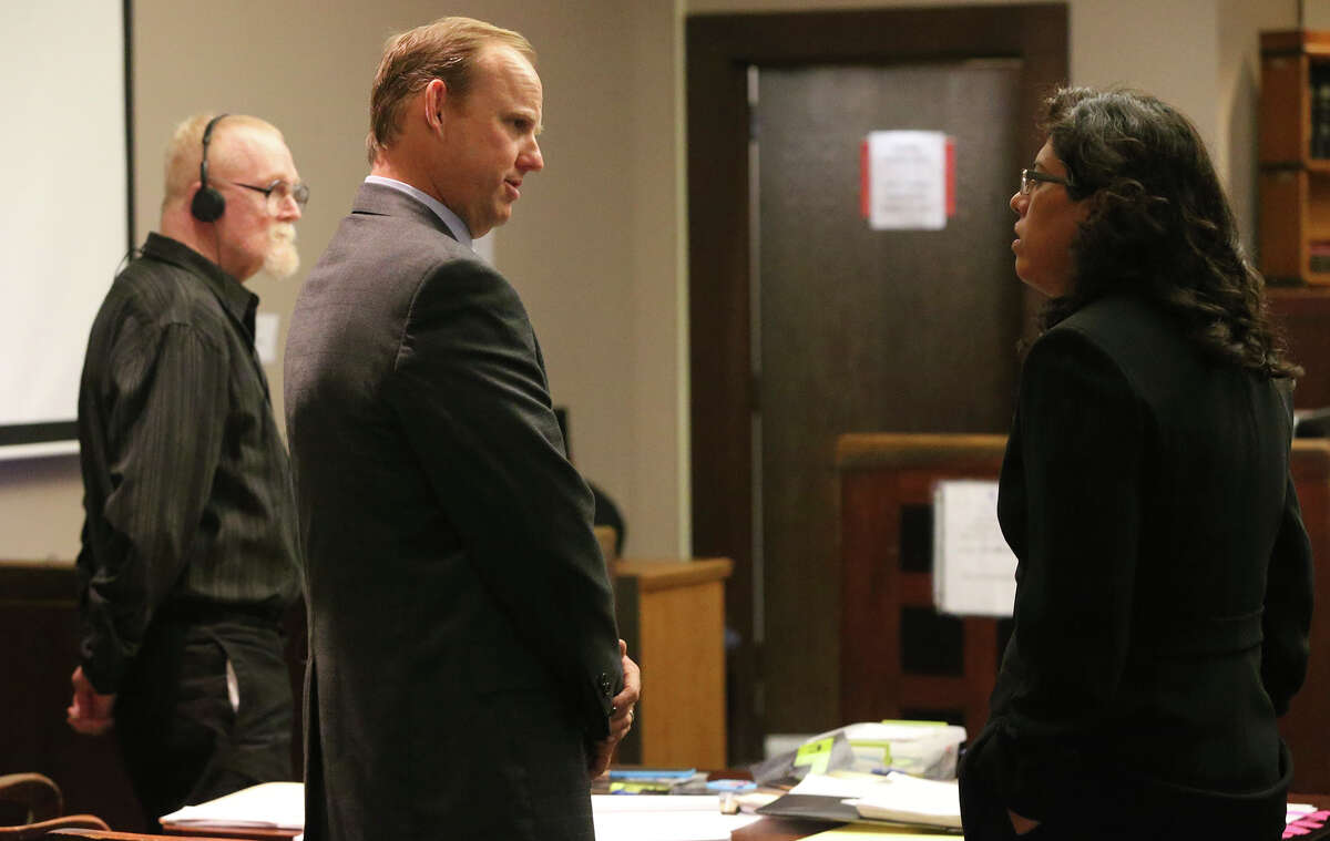 Defense attorneys Brandon Hudson (center) and Jennifer Pena (right) talk to each other Tuesday November 10, 2015 during the murder trial of Dennis Cosby (left). Cosby is accused of shooting to death Paul M. Quiroga February 23, 2014.