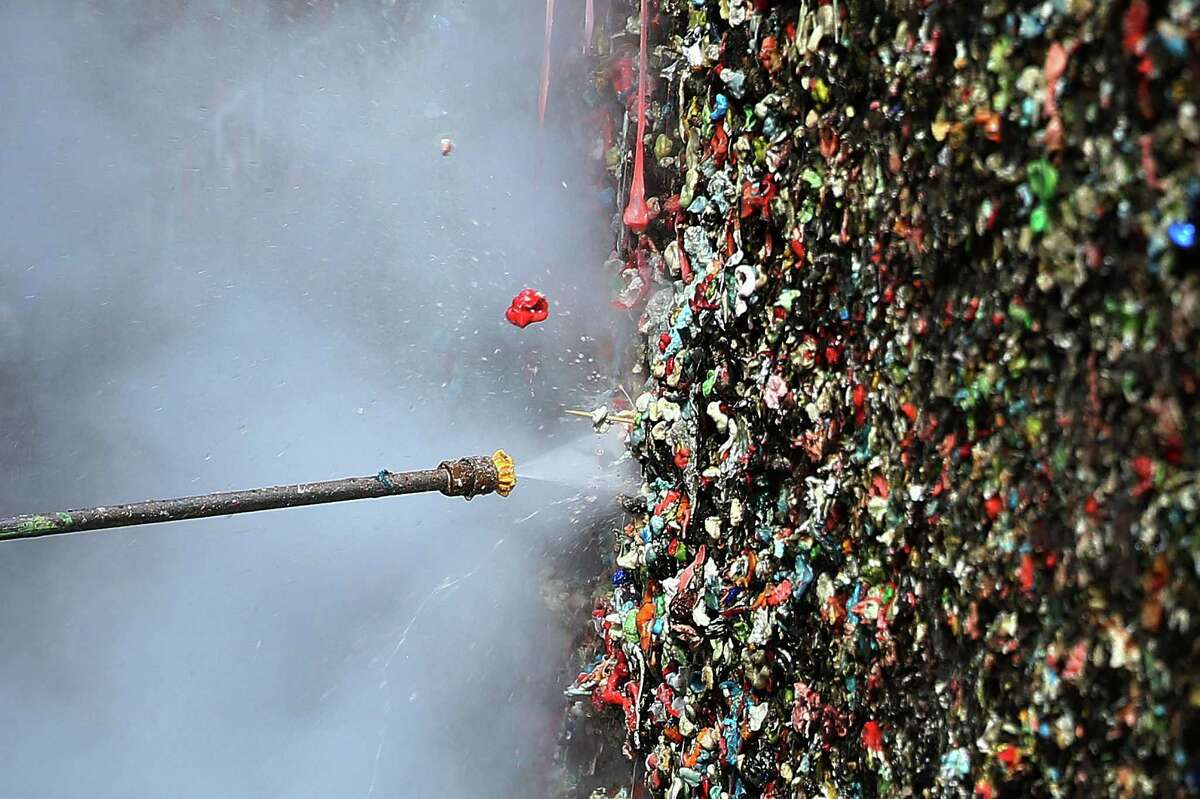 Workers began cleaning 20 years worth of gum from the walls of Post Alley at Pike Place Market, Tuesday, Nov. 10, 2015.