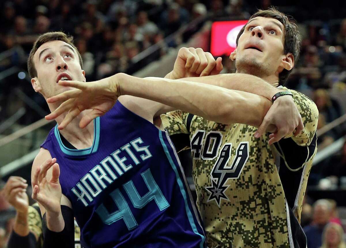 Charlotte Hornets' Frank Kaminsky and San Antonio Spurs' Boban Marjanovic struggle for position on a free throw during second half action Saturday Nov. 7, 2015 at the AT&T Center. The Spurs won 114-94.