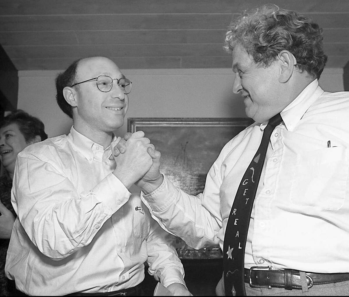 REAL Party BET candidates, Howard Richman, left, and Peter Gasparino shake hands in a show of support just prior to listening to the election results on the radio at fellow party member Nan Markel’s house in Old Greenwich, Nov. 7, 1995.