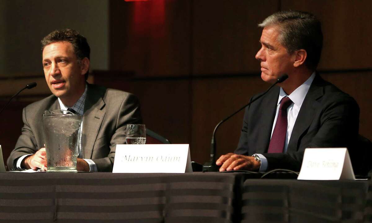 Kyle Danish, left, with Shell Oil President Marvin Odum during the panel discussion at the University of Houston energy symposium, "Carbon tax: Is it the right time?" on Tuesday, Nov. 10, 2015. ( Karen Warren / Houston Chronicle )