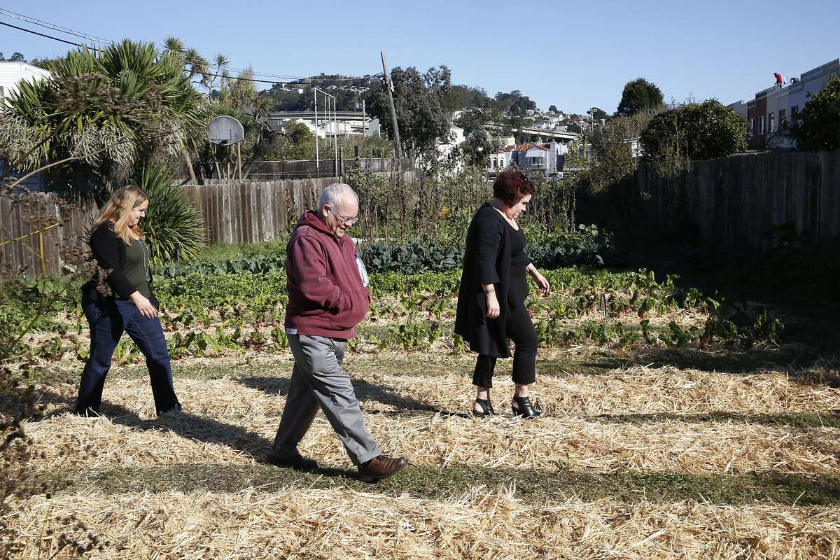 Neighbors Kerry Evensong (left), David Hooper (middle), and Nancy Huff (right) show and talk about the Little City Farm site in San Francisco, California, on Tuesday, November 10, 2015. A private school, Golden Bridges School, is proposing to build it's campus on the Little City Farm site in the Excelsior.
