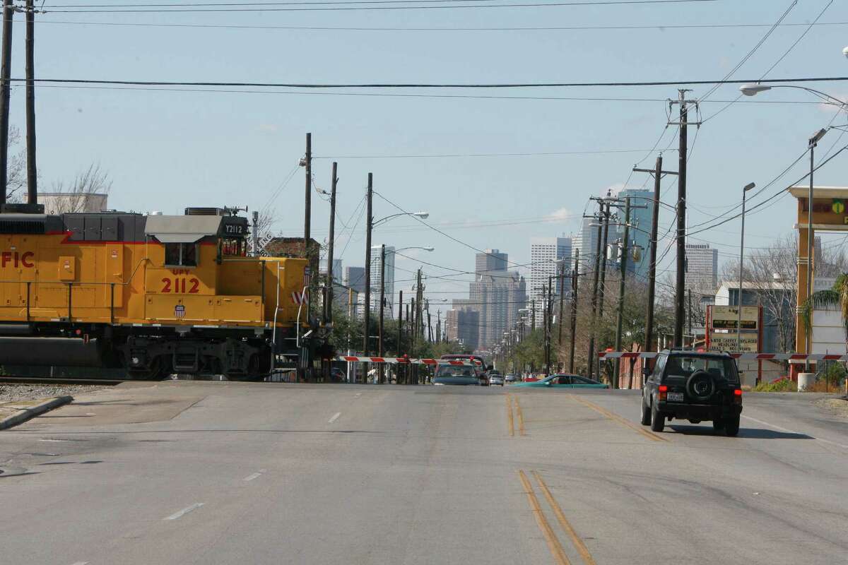 Guard rails are seen down as an approaching train is about to cross on the track at Harrisburg Boulevard near Hughes Street in Houston's East End on Feb. 5, 2009. At the time, residents were vehemently opposed to a six-block long overpass.