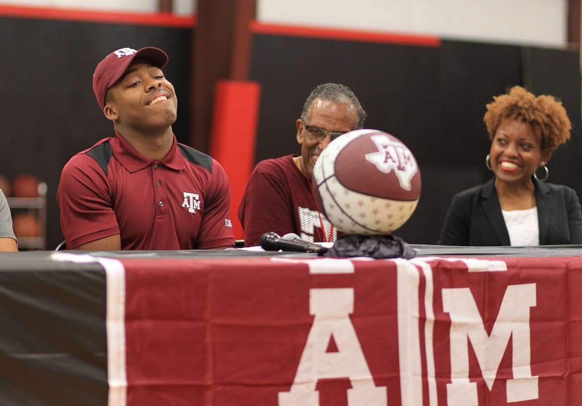J.J. Caldwell reacts after signing his national letter of intent with Texas A&M University during a ceremony at Elevation Skills Sports in Cypress, Wednesday, Nov. 11, 2015. ( Mark Mulligan / Houston Chronicle )