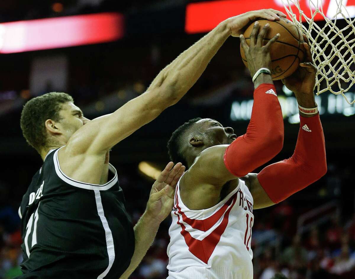 Brooklyn Nets center Brook Lopez (11) blocks a shot by Houston Rockets center Dwight Howard (12) during the second half of an NBA basketball game at Toyota Center Wednesday, Nov. 11, 2015, in Houston.