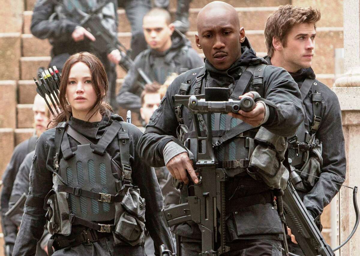 Jennifer Lawrence (from left), Mahershala Ali and Liam Hemsworth star in “Mockingjay Part 2.”