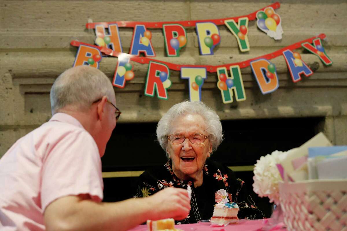 Hilda Matson (center) breaks into laughter while chatting with grandson-in-law Matt Even during her birthday celebration.