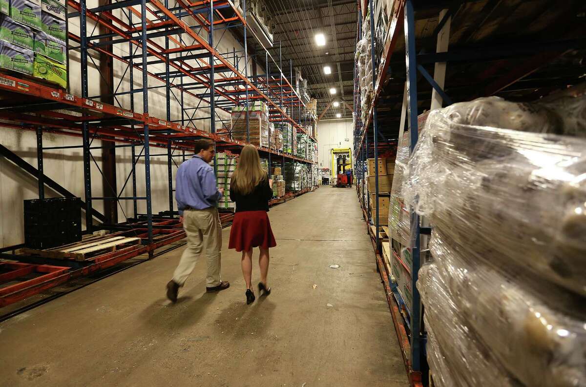 Brian Green, president and CEO of the Houston Food Bank, gives a tour of the facility to former first daughter Chelsea Clinton on Thursday, Oct. 15, 2015. ( Elizabeth Conley / Houston Chronicle )