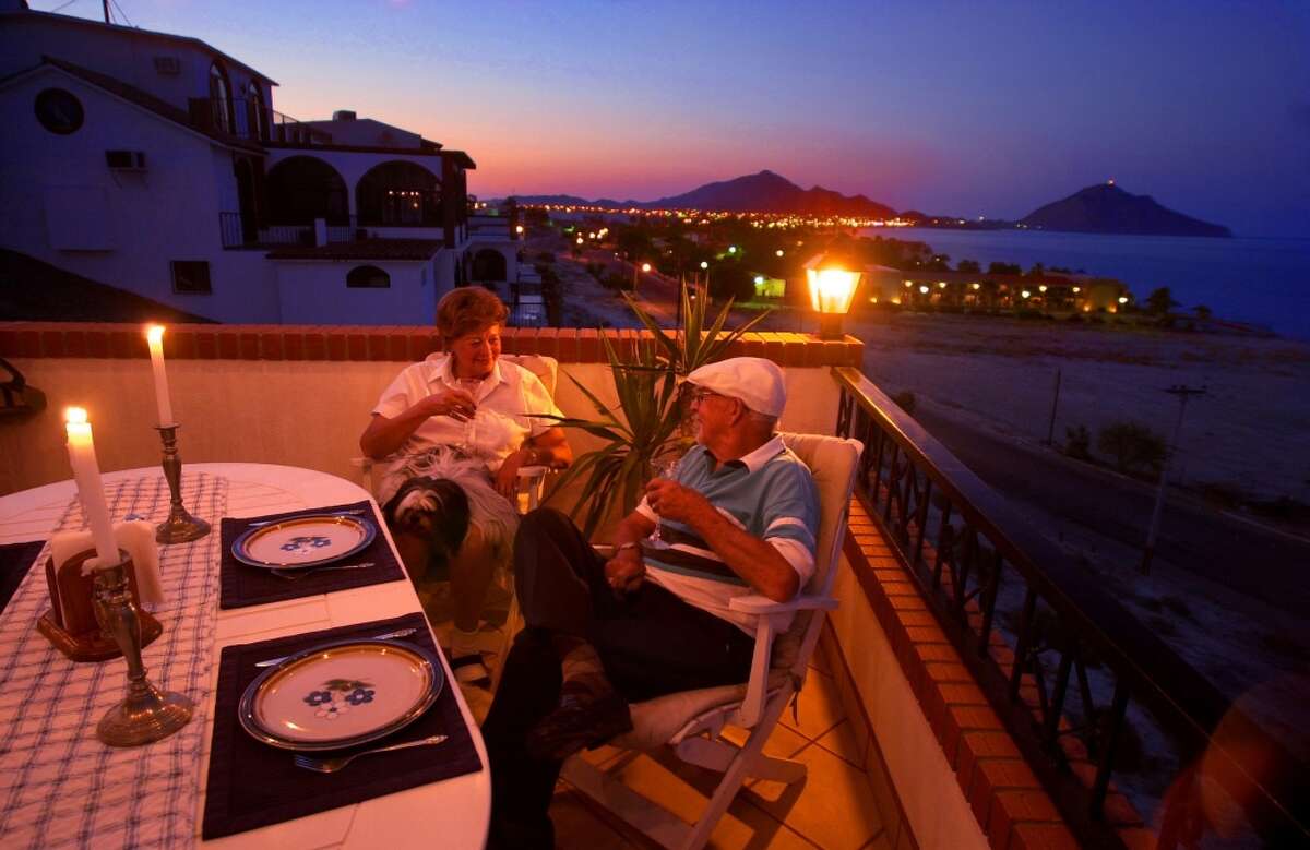 Dorothy and Jack Biely dining by candlelight on their balcony overlooking the Sea of Cortez, a retired couple from California living the affordable good life in one of a handful of Mexican towns attracting American retirees. Keep clicking to find the Mexican town with the highest population of U.S. retirees.