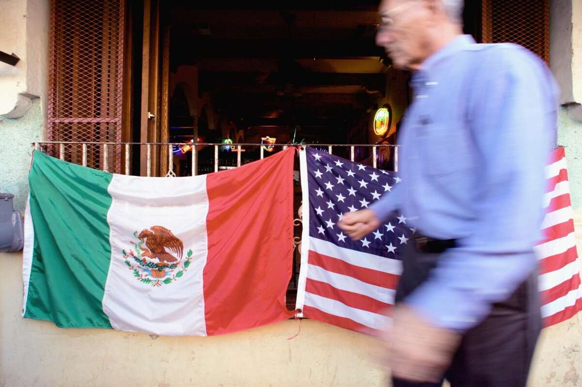 Nuevo Laredo A man walks in front of a bar with flags of Mexico and the USA in Nuevo Laredo City, Tamaulipas State, north of Mexico, 01 March 2006.