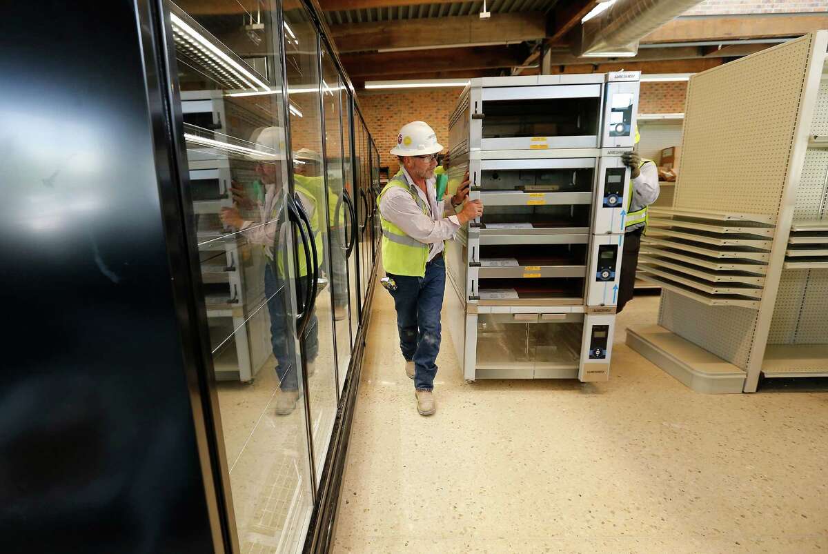 Crews bring bakery ovens into the downtown H-E-B grocery store. The store will emphasize grab-and-go prepared food and drinks.