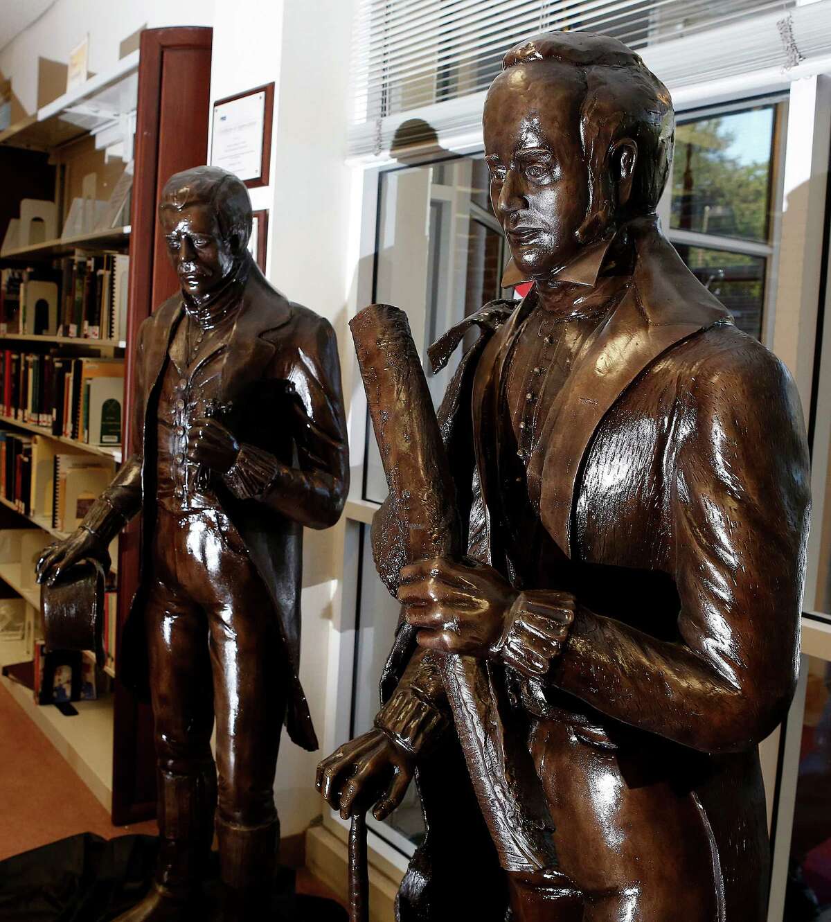 Statues of the Allen brothers, Augustus Chapman Allen (left) and John Kirby Allen (right), created by artist Lori Betz, are currently sitting in the entrance of the Clayton Library Center for Genealogical Research, Thursday, Nov. 12, 2015, in Houston. The city plans to install the statues at the east entrance to city hall later this month.