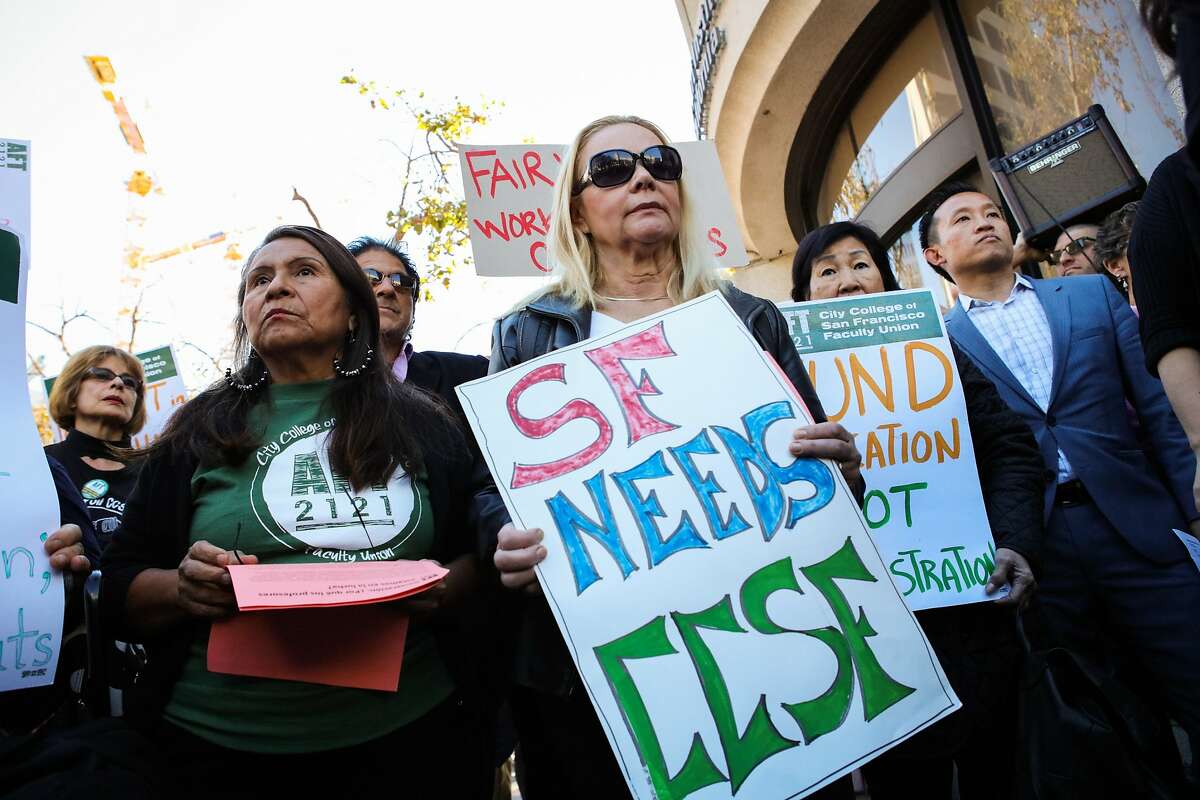 Teacher Ana Fisher (second from left) and Assembly member David Chiu (right) came out to protest the budget cuts that are being made at CCSF at UN Plaza in San Francisco, California on Thursday, November 12, 2015.