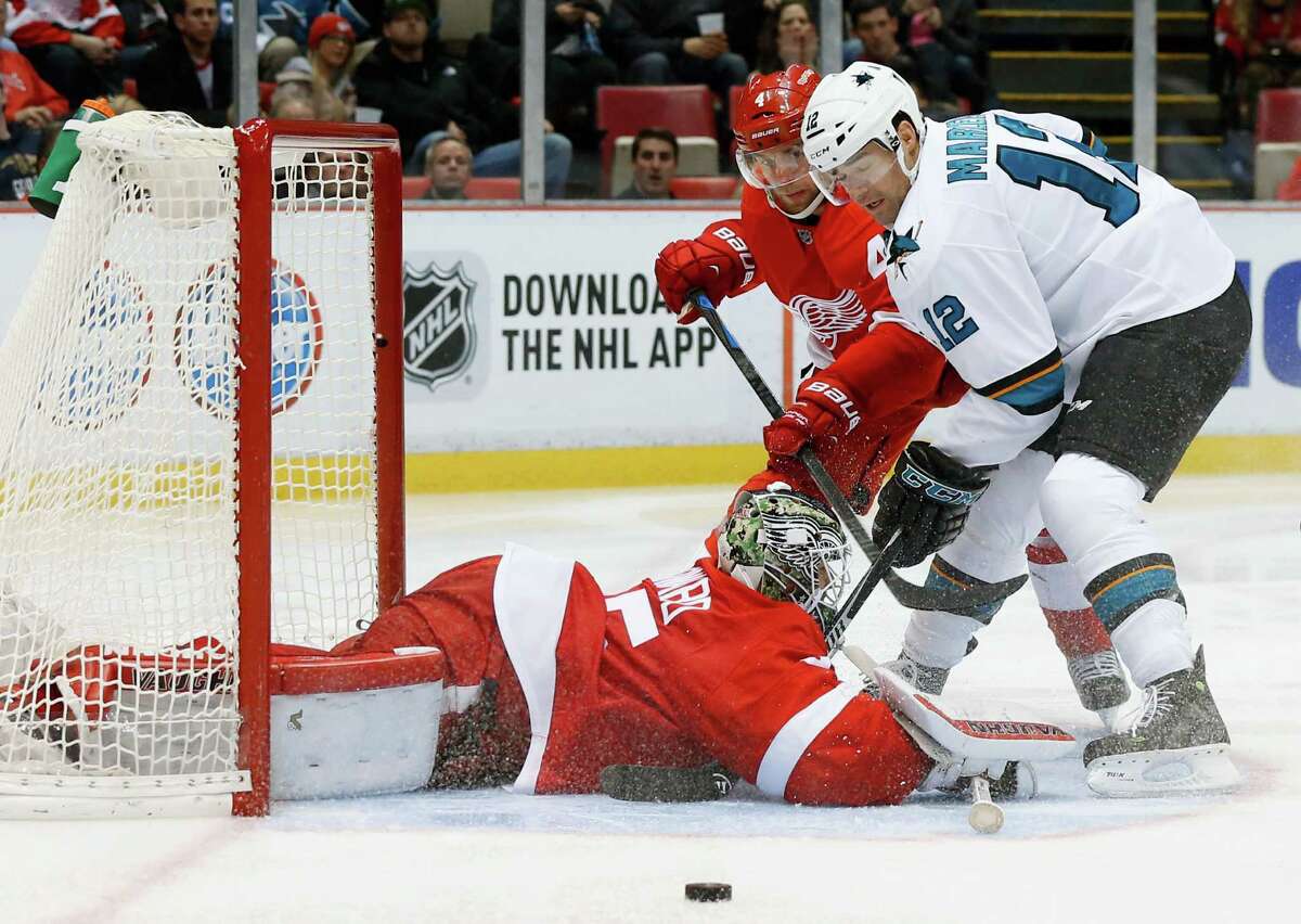 Detroit Red Wings goalie Jimmy Howard (35) stops a San Jose Sharks center Patrick Marleau (12) shot as Jakub Kindl (4) defends in the third period of an NHL hockey game Friday, Nov. 13, 2015 in Detroit. (AP Photo/Paul Sancya) ORG XMIT: MIPS111