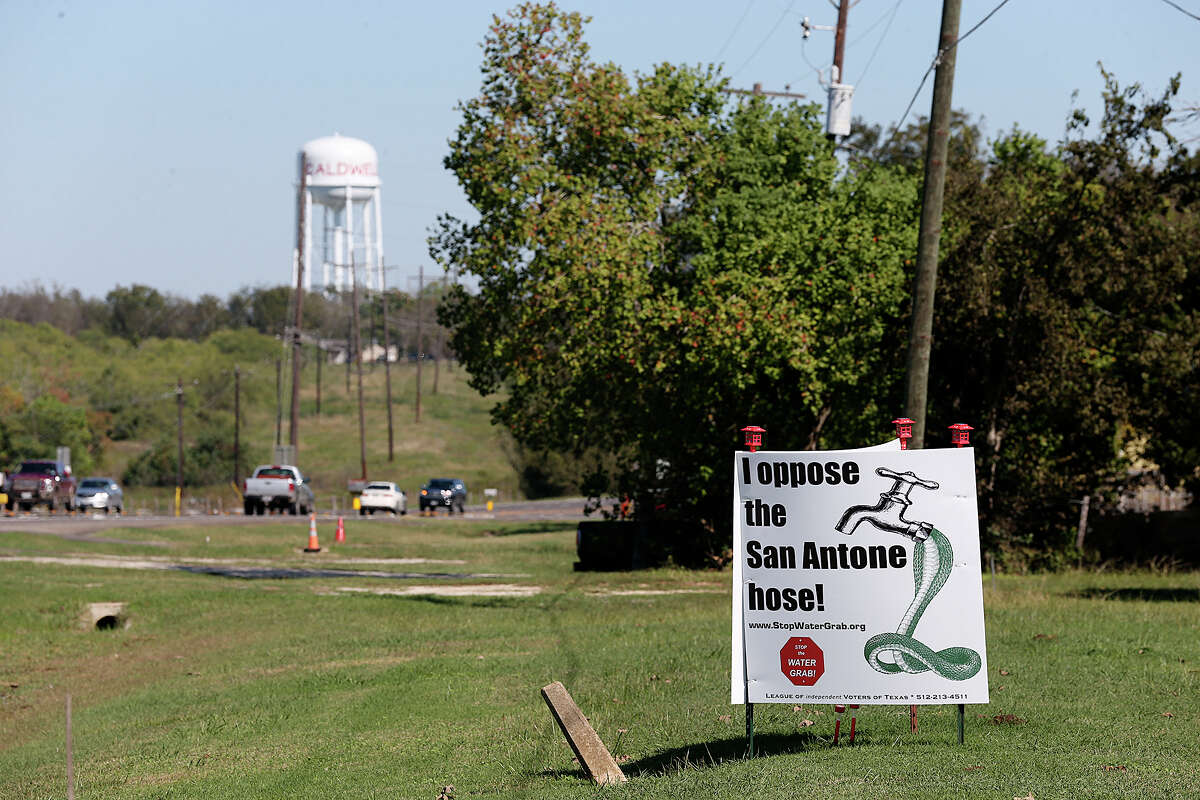 Signs against the proposed San Antonio Water System's Vista Ridge project are seen at a residence along Texas State Highway 21 in Caldwell, Texas, Sunday, Nov. 8, 2015. Caldwell is the Burleson County seat and SAWS plans on piping water from Burleson and Milam counties to San Antonio through their Vista Ridge Project. The multi billion dollar project has drawn objections from area landowners and San Antonio activist.
