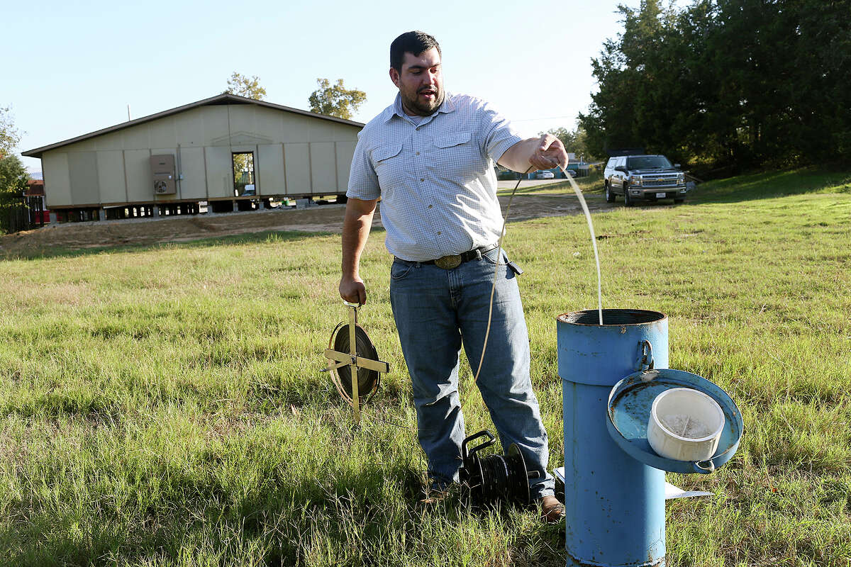 Bobby Bazan, water resource management specialist with Post Oak Savannah Groundwater Conservation District, measures Monitoring Well 9166 in Milano on Nov. 3. The district regulates the pumping of groundwater in part of the Carrizo-Wilcox Aquifer. That is the aquifer San Antonio wants to tap as a new water source and would pipe the water 142 miles from Burleson County.