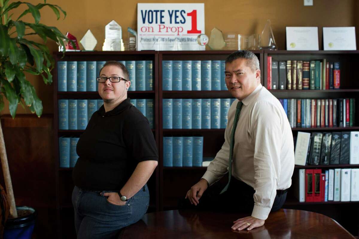 H.C. Bailey, left, works at a law office with attorney John Nechman, a Korean immigrant who fought his way through adolescence in 1970s Houston as a gay Asian in an America still licking its Vietnam War wounds. ﻿