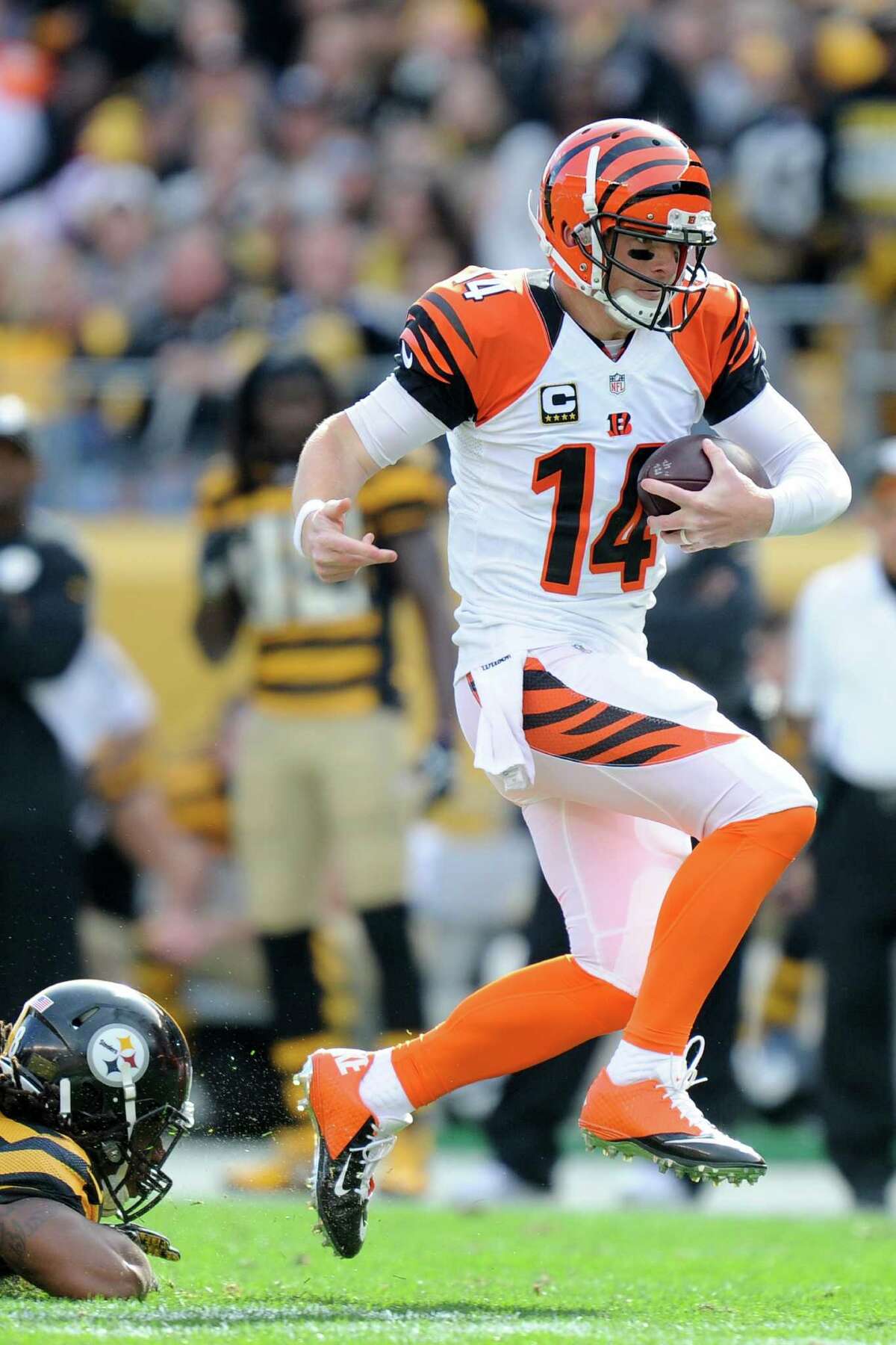 Cincinnati Bengals quarterback Andy Dalton (14) walks off the