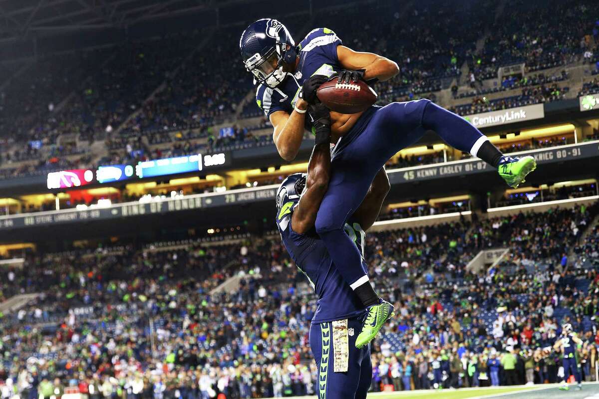 Seattle's Doug Baldwin (above) jumps into the arms of Kam Chancellor before the start of their game against the Cardinals, Sunday, Nov. 15, 2015 at CenturyLink Field.