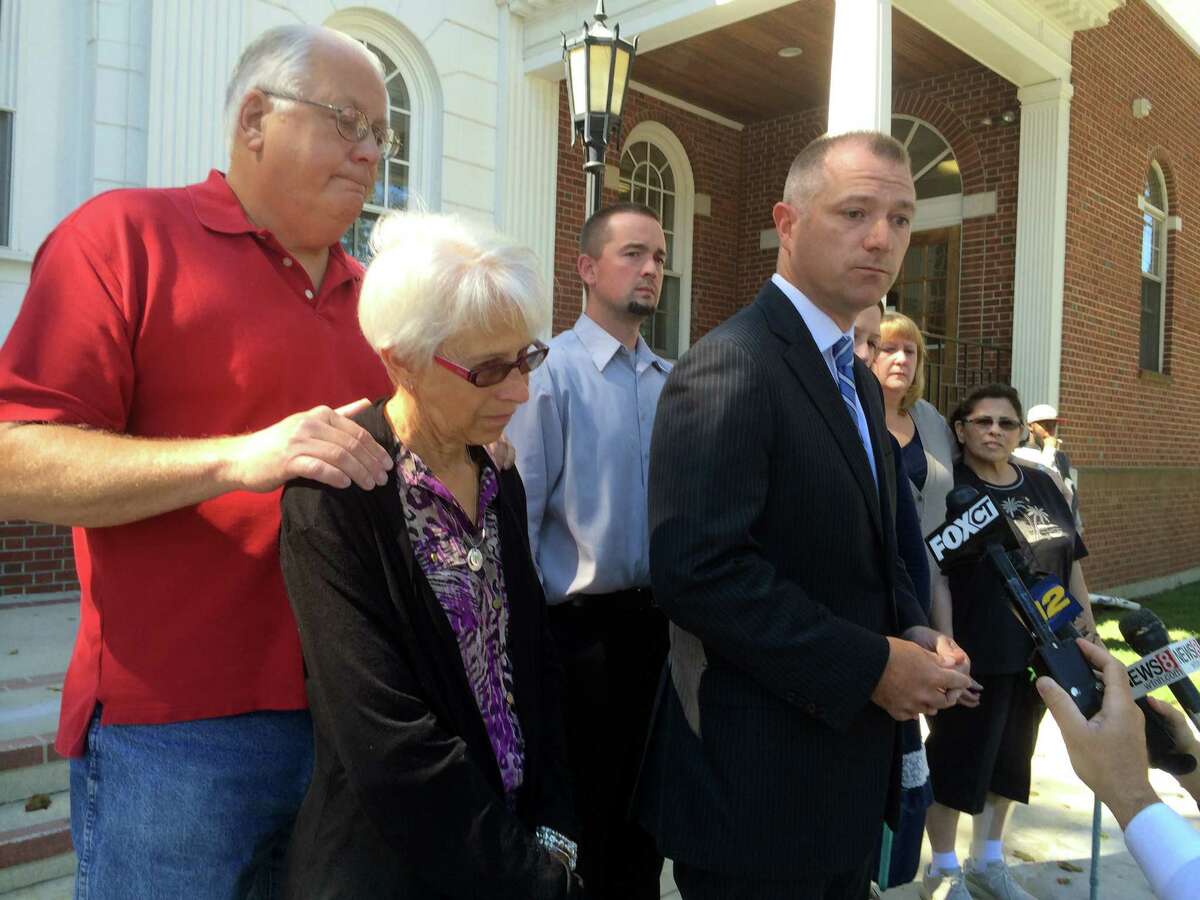 FILE PHOTO: Milford State's Attorney Kevin Lawlor stands outside the Superior Courthouse with Merry Jackson, left, and her husband, Douglas Jackson, far left, moments after Scott Gellatly pleaded guilty to killing Lori Jackson, his estranged wife and attempting to kill Merry in Oxford on May 7, 2014.
