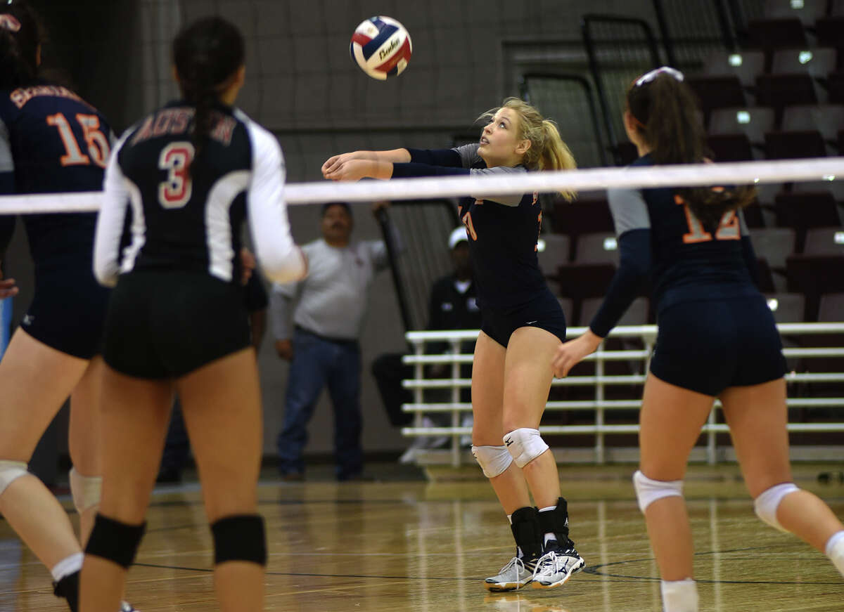 Seven Lakes junior outside hitter Natalie Batton, center, makes a play against Fort Bend Austin during their Class 6A Region III volleyball championship match at the Campbell Center in Houston on Saturday, Nov. 14, 2015. (Photo by Jerry Baker/Freelance)